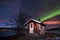 Polar arctic Northern lights aurora borealis sky star in Scandinavia Norway Tromso in the farm winter snow mountains