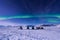 The polar arctic snowmobile Northern lights aurora borealis sky star in Norway Svalbard in Longyearbyen city moon mountains
