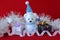 Polar bear wearing a hat and a blue scarf posed next to gifts with shiny knots on a Christmas holiday decor