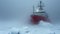 Polar expedition during storm in mist, frozen ship icebreaker sails in ice on snow background. Concept of arctic exploration,