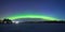 Polar northen lights aurora borealis at night in the starry sky above the lake with the island and the silhouette of the trees by