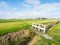 Polder landscape with bridge over ditch and grassland near Workum, Friesland, Netherlands