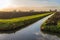 Polder landscape with plowed fields and a ditch diagonally in the image