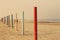 Pole barrier on beachfront against beach sea ond blue sky landscape