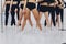 pole dance concept, a group of girls gymnasts train, close-up of bare healthy legs in training.