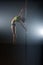 Pole dance. Graceful dancer performs acrobatic pas