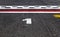 Pole position number one sign on asphalt race track, motor sports symbols