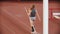 Pole vault training on the stadium - young woman with long hair running on the track