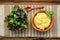 Polenta with basil shoot in wooden bowl with green salad and woo