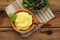 Polenta with basil shoot in wooden bowl with green salad and woo