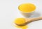 Polenta or Cornmeal Flour. Ground Dried Corn or Corn Grits in a white bowl and wooden spoon close-up