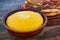 Polenta is a dish made from corn flour, served with a book and cheese.