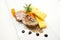 Polenta, roasted pork and rosemary with balsamic reduction on a white plate