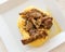 Polenta with small goat roasted