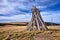 Poles for marking tourist trails in a meadow on a plain during autumn