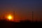 Poles of power lines at sunset - industrial landscape