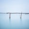 Poles and soft water on water landscape. Long exposure.