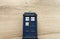 Police call box isolated on wooden background. Tardis from Doctor Who.