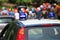 police car with blue sirens in the street escorting participants