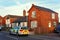 Police car parked outside a red brick house