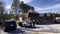 Police cars and officers investigators and crime scene tape at a vintage vacant strip mall