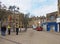 Police community support officers talk to people outside old buildings and shops in oastler square in bradford west yorkshire