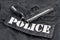 Police concept - handgun on black uniform