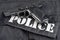 Police concept handgun on black uniform background