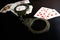 Police handcuffs and playing cards