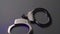 Police handcuffs on white desk close-up