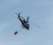 Police helicopter carrying water bucket