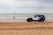 Police jeep driving on the beach