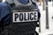 \\\'POLICE\\\' marking written on the back of a bulletproof vest worn by a French police officer in Paris, France