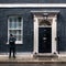A police officer guards the entrance door of 10 Downing Street in London, UK