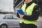 Police officer in a reflective vest writing a ticket