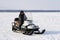 Police officer on a snowmobile among the tundra in winter in Siberia