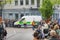 Police officers help an ambulance drive through a crowd of people