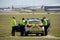 Police officers with marked patrol car guarding airport runway keeping aircraft passengers safe secure