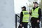 Police officers in reflective vests patrol the streets of the city