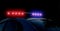 Police patrol on the street at night. Flashing red and blue police car lights in night time. Light alarm emergency flashing siren
