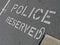 Police reserved as text on asphalt, security,