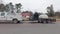 Police and a road cleaning crew cleaning a red substance on the highway