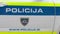 Police sign with emergency dial number on the side of patrol car