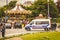 Police truck is parked in the street next to a carousel