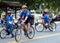 Policeman on bike patrol is joined in patroling by kids on bikes