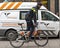 Policeman cycling and guiding the pet ambulance