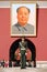 Policeman and Mao\'s portrait