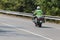 Policeman riding on a motorbike, rear view