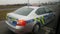 Policeman sits in the car on the road and drive