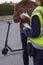 Policeman stops a boy on electric scooter